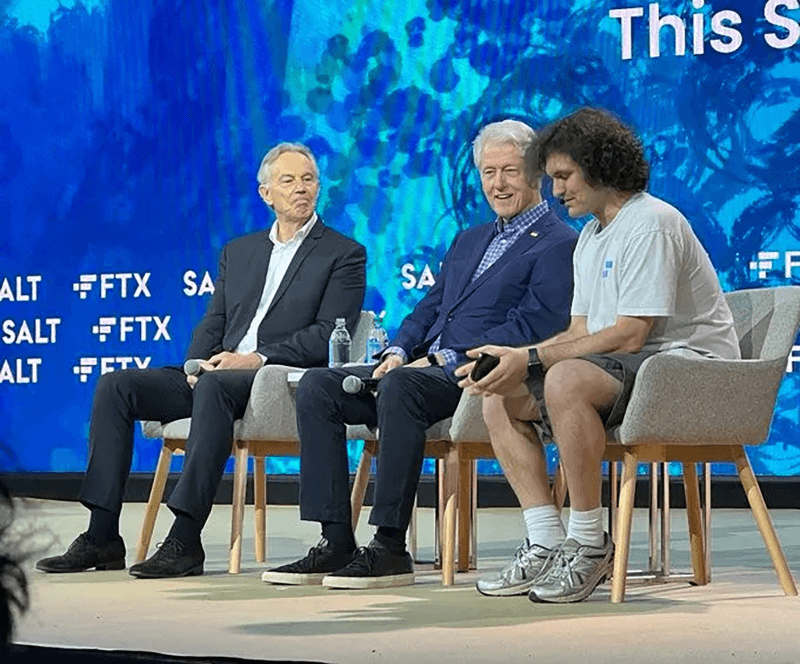 Sam Bankman Fried and Bill Clinton and Tony Blair sitting on stage together